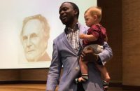 professor-holds-students-child-during-class