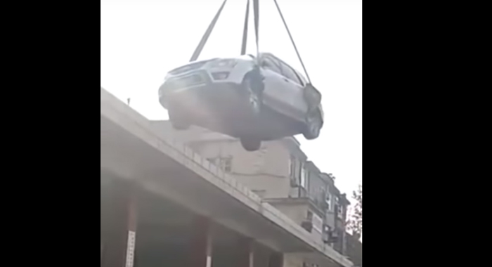 illegally-parked-vehicle-hoisted-onto-roof
